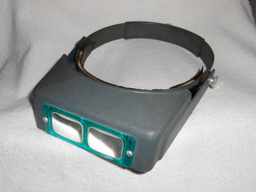 The Optivisor visor magnifier has worked for me and is available in six magnification levels.